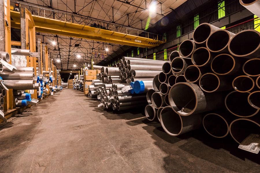 Industrial warehouse with stacked structural steel pipes