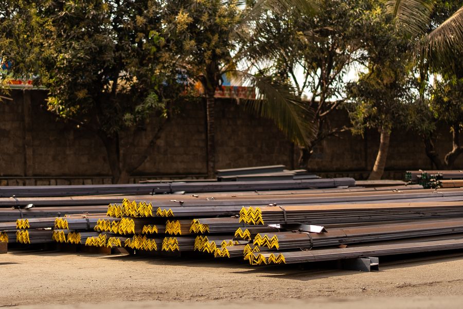 Stacked MS round and square bars in an outdoor yard