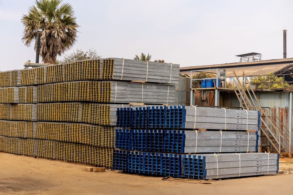 Stacked MS structural steel beams in Noble Steel Corporation's supply yard